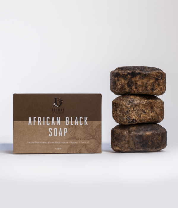 Three bars of Deluxe African Black Soap bar next to product box.