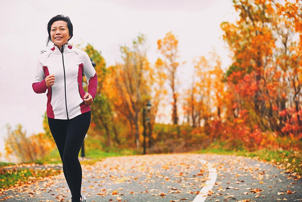 Deluxe Shea Butter Autumn Skin Care Tips - woman jogging in autumn