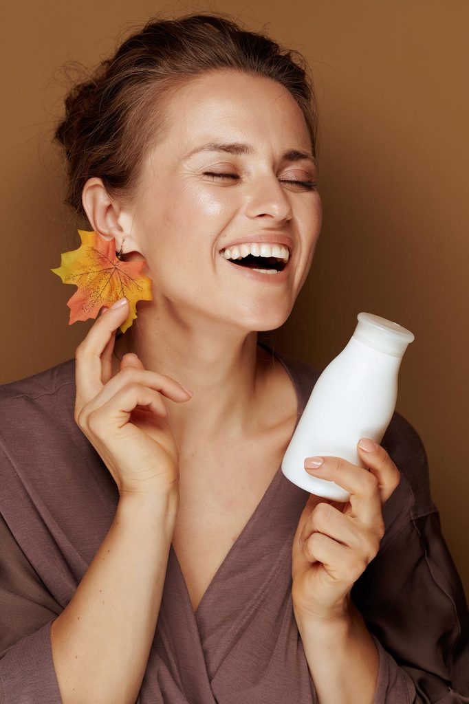 Deluxe Shea Butter Autumn Skin Care Tips - woman with face cleanser laughing